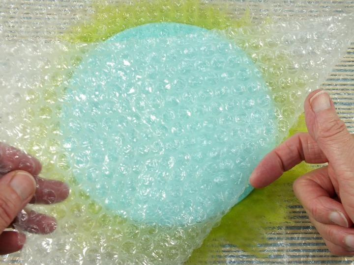 Release trapped fibres as you lift bubble wrap