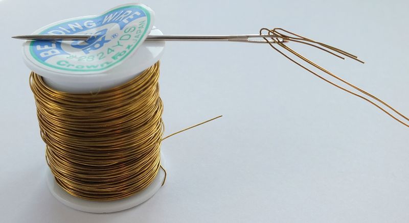 Thread wire through large needle to pass through snowball