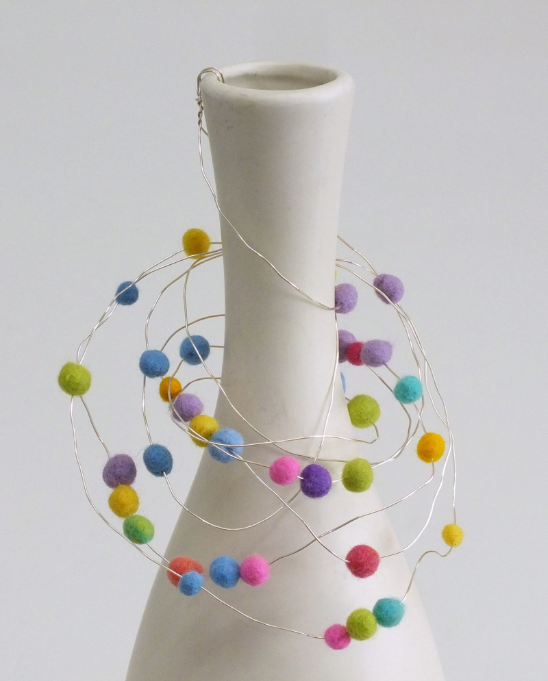 Bead hanger hooked into neck of vase