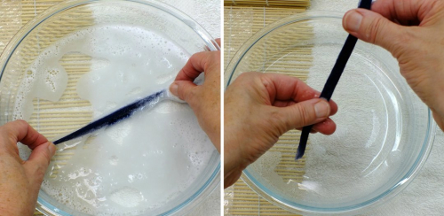 Wetting and smoothing a tuft of wool fibres