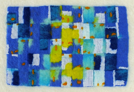 Cut felt re-felted onto loose white merino fibres